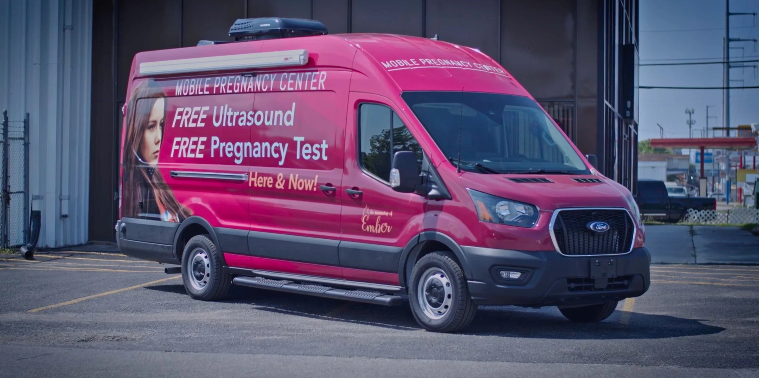 A Vans for Life mobile pregnancy center van parked on the street